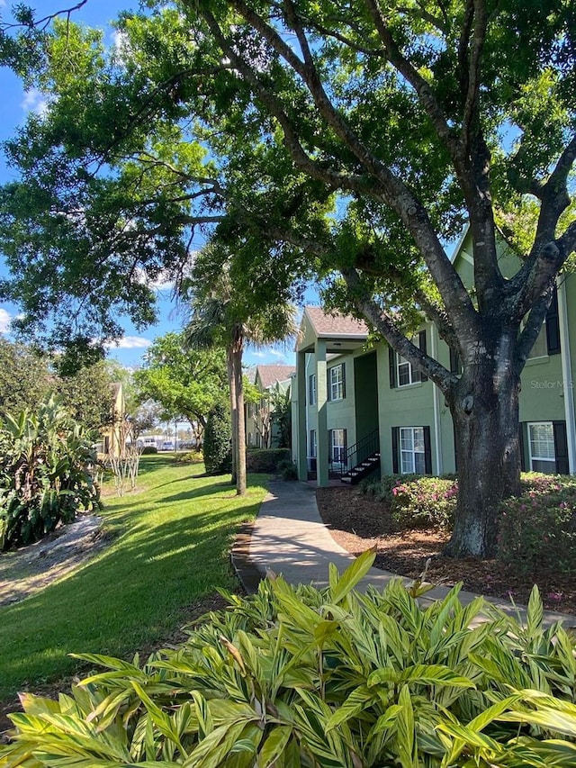 2007 Dixie Belle Dr Unit 2007M, Orlando, FL 32812 - view of green lawn featuring stairway
