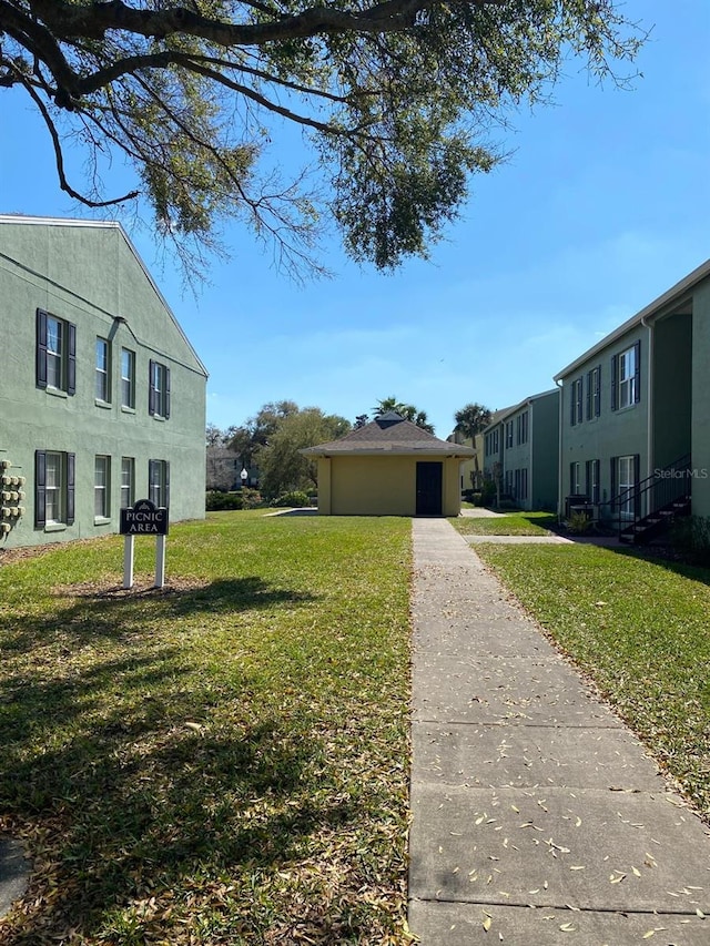 2007 Dixie Belle Dr Unit 2007M, Orlando, FL 32812 - view of grassy yard featuring driveway