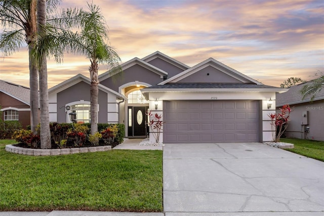 2520 Oakington St, Winter Garden, FL 34787 - ranch-style home with stucco siding, a garage, concrete driveway, and a front yard