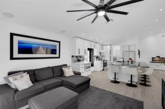 2520 Oakington St, Winter Garden, FL 34787 - living room with light wood-style floors, ceiling fan, recessed lighting, and lofted ceiling