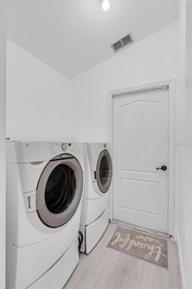 2520 Oakington St, Winter Garden, FL 34787 - laundry area featuring separate washer and dryer and light wood-style flooring