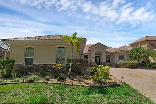 2801 Boat Cove Cir, Kissimmee, FL 34746 - mediterranean / spanish-style house with a tile roof, stucco siding, and stone siding