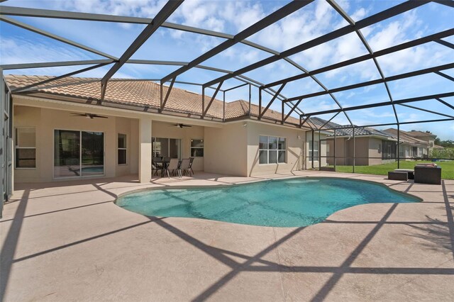 2801 Boat Cove Cir, Kissimmee, FL 34746 - outdoor pool featuring ceiling fan, a patio area, and glass enclosure