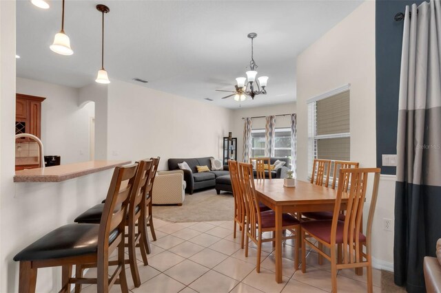 2801 Boat Cove Cir, Kissimmee, FL 34746 - dining space featuring light colored carpet, a chandelier, and light tile patterned floors