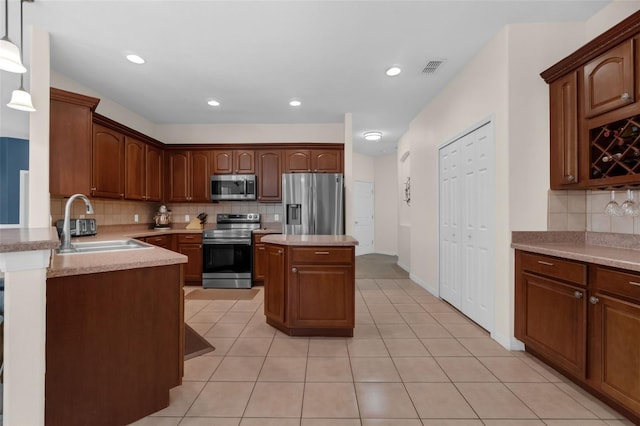 2801 Boat Cove Cir, Kissimmee, FL 34746 - kitchen with appliances with stainless steel finishes, a sink, tasteful backsplash, light countertops, and light tile patterned floors