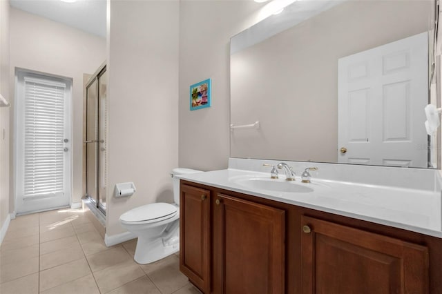 2801 Boat Cove Cir, Kissimmee, FL 34746 - bathroom featuring tile patterned floors, toilet, vanity, a shower stall, and baseboards