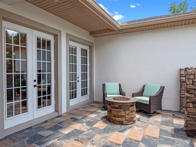 20199 Sweetwood Ln, Clermont, FL 34715 - view of patio featuring french doors and a fire pit