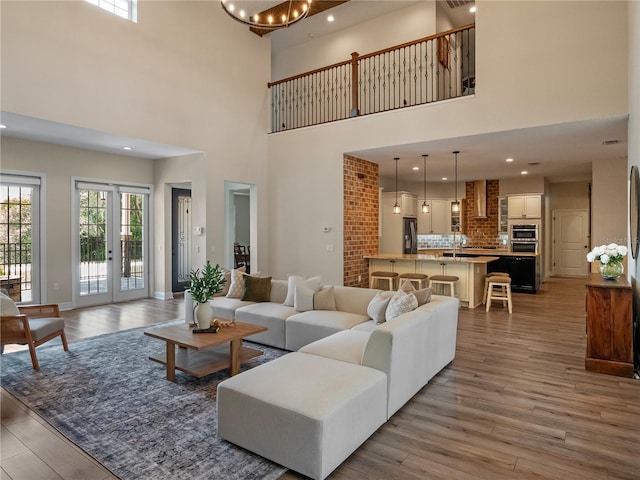 20199 Sweetwood Ln, Clermont, FL 34715 - living area featuring a high ceiling, wood finished floors, and a chandelier