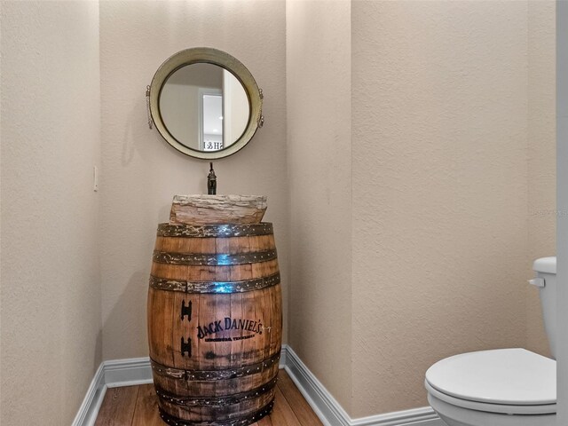 20199 Sweetwood Ln, Clermont, FL 34715 - bathroom featuring wood finished floors, toilet, and baseboards