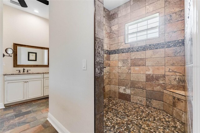 20199 Sweetwood Ln, Clermont, FL 34715 - full bathroom with baseboards, walk in shower, stone finish flooring, and vanity