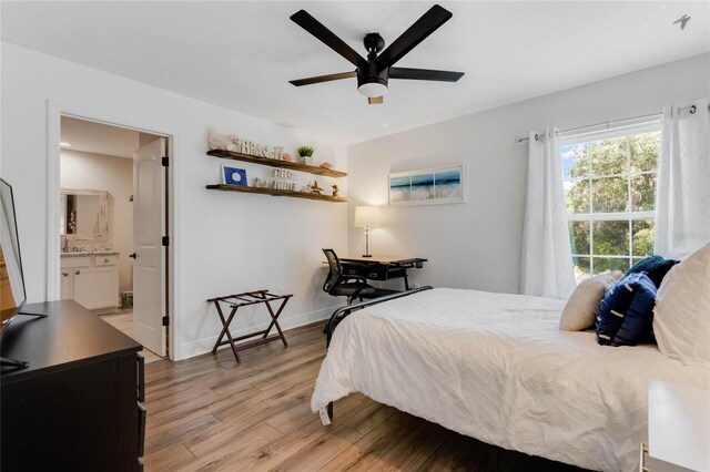 20199 Sweetwood Ln, Clermont, FL 34715 - bedroom featuring light wood-type flooring, baseboards, a ceiling fan, and ensuite bathroom