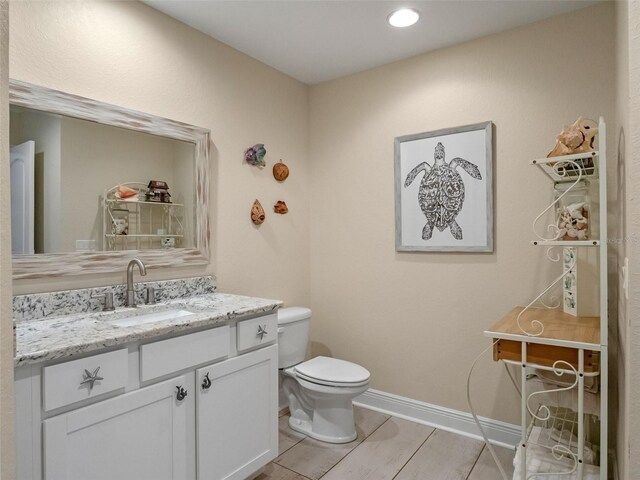 20199 Sweetwood Ln, Clermont, FL 34715 - bathroom with toilet, vanity, and baseboards