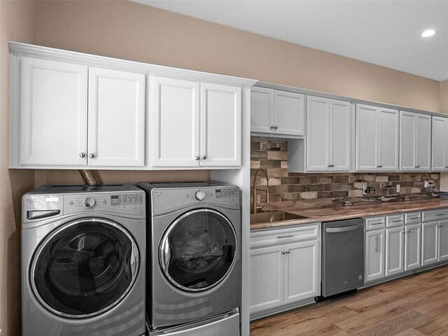 20199 Sweetwood Ln, Clermont, FL 34715 - laundry room with washing machine and clothes dryer, light wood finished floors, and recessed lighting