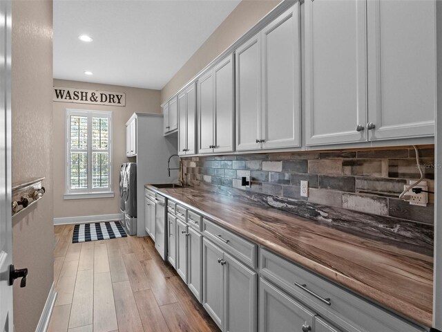 20199 Sweetwood Ln, Clermont, FL 34715 - kitchen with tasteful backsplash, baseboards, dishwasher, a sink, and recessed lighting
