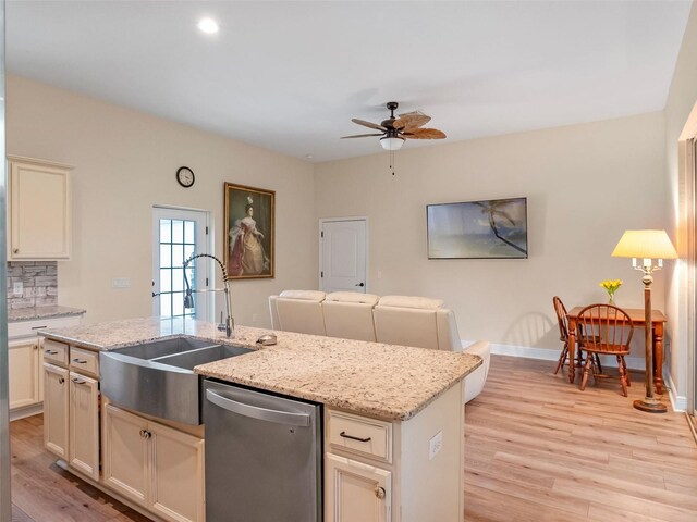 20199 Sweetwood Ln, Clermont, FL 34715 - kitchen with stainless steel dishwasher, a ceiling fan, a sink, light wood-type flooring, and a center island with sink