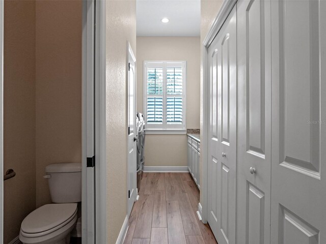 20199 Sweetwood Ln, Clermont, FL 34715 - bathroom with toilet, wood finished floors, baseboards, and a closet