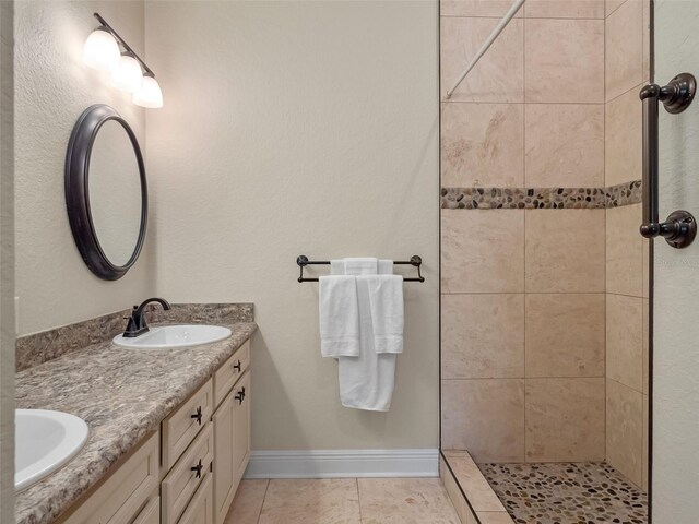 20199 Sweetwood Ln, Clermont, FL 34715 - full bath with double vanity, tile patterned floors, tiled shower, and baseboards