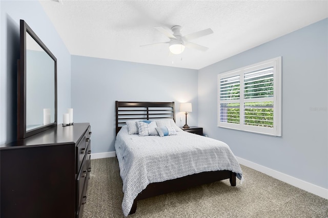 5370 Whispering Pine Cir, Saint Cloud, FL 34771 - bedroom with baseboards, dark carpet, a textured ceiling, and a ceiling fan