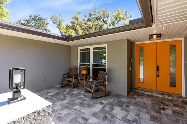 5370 Whispering Pine Cir, Saint Cloud, FL 34771 - view of exterior entry featuring stucco siding and a patio area