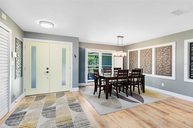 5370 Whispering Pine Cir, Saint Cloud, FL 34771 - dining room featuring a chandelier, wood finished floors, and baseboards