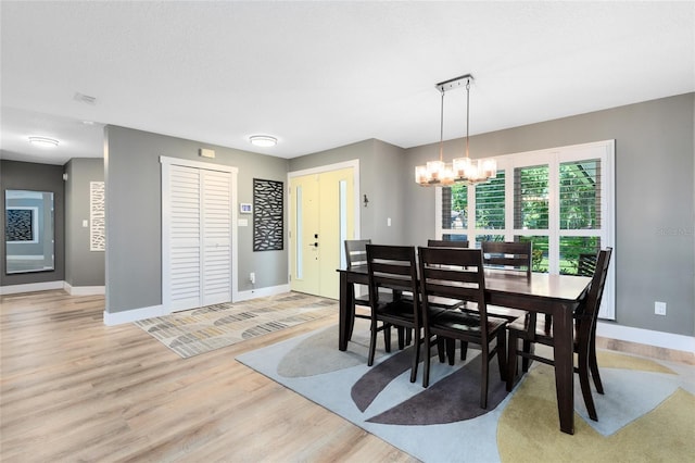5370 Whispering Pine Cir, Saint Cloud, FL 34771 - dining area with baseboards, a chandelier, and light wood-style flooring