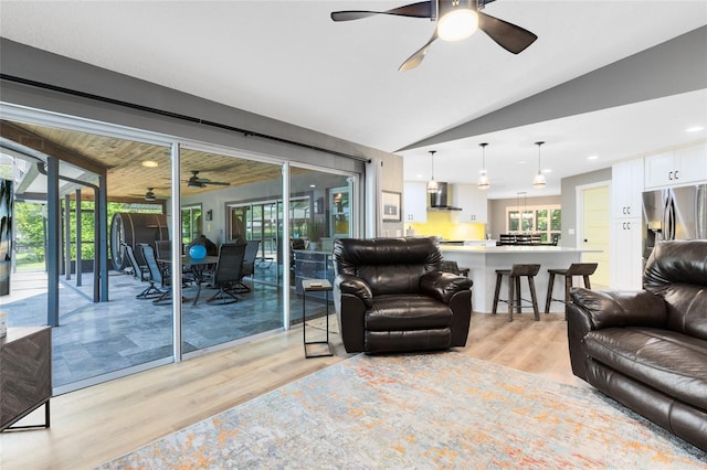 5370 Whispering Pine Cir, Saint Cloud, FL 34771 - living area featuring a ceiling fan, light wood-style floors, lofted ceiling, and plenty of natural light