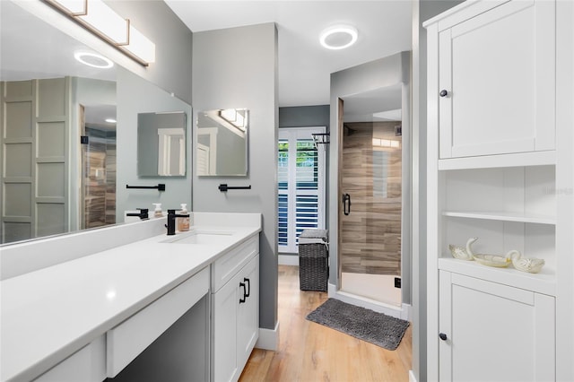 5370 Whispering Pine Cir, Saint Cloud, FL 34771 - full bathroom featuring vanity, a shower stall, and wood finished floors