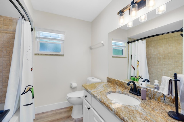 5370 Whispering Pine Cir, Saint Cloud, FL 34771 - bathroom with plenty of natural light, wood finished floors, vanity, and toilet