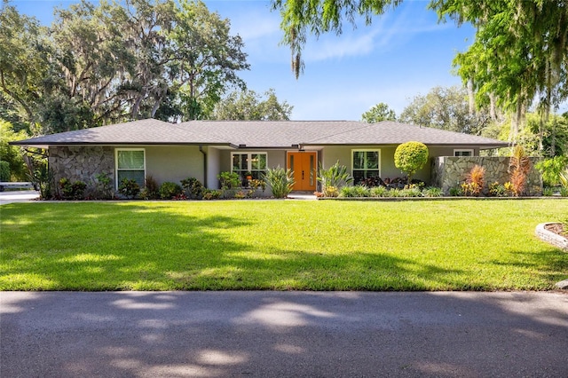 5370 Whispering Pine Cir, Saint Cloud, FL 34771 - single story home with stucco siding, a front lawn, and stone siding