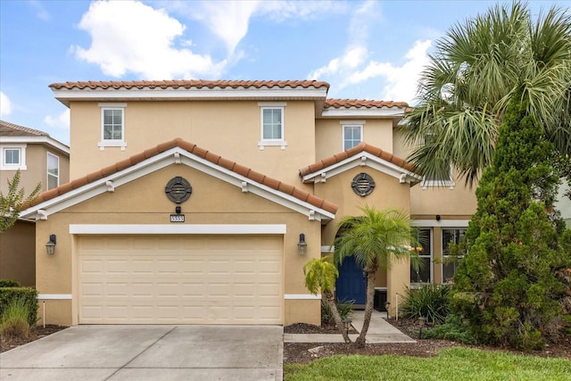 5353 Oakbourne Ave, Davenport, FL 33837 - mediterranean / spanish-style house with a garage, a tile roof, concrete driveway, stucco siding, and central AC