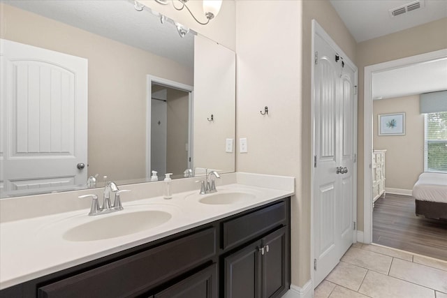 5353 Oakbourne Ave, Davenport, FL 33837 - bathroom with tile patterned floors, double vanity, ensuite bath, and baseboards