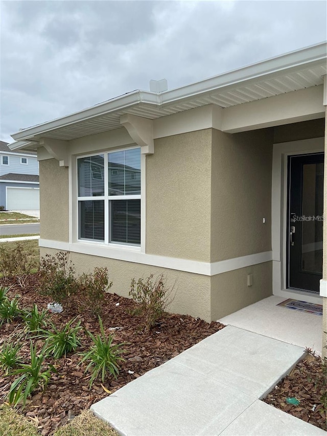 view of side of home featuring stucco siding