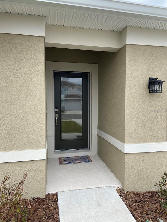 property entrance featuring stucco siding
