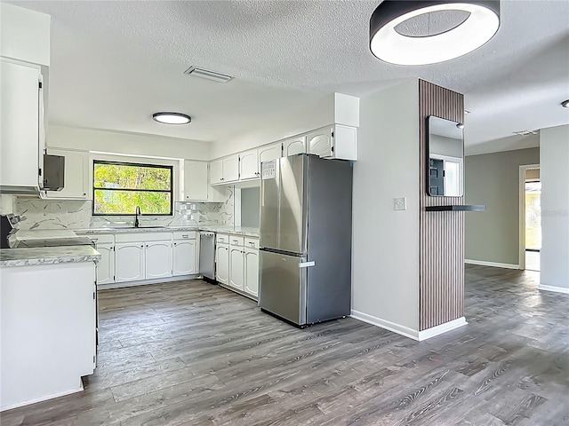 43 Lake Court Loop, Ocala, FL 34472 - kitchen with stainless steel appliances, a sink, dark wood-type flooring, light countertops, and white cabinets
