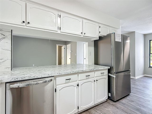 43 Lake Court Loop, Ocala, FL 34472 - kitchen featuring stainless steel appliances, white cabinets, light wood-style floors, and baseboards
