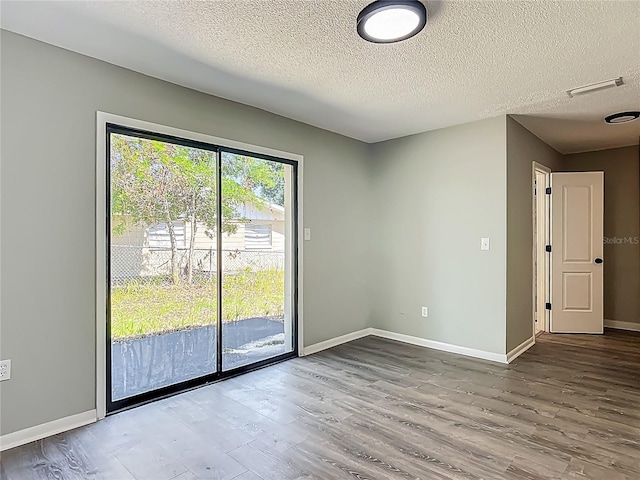 43 Lake Court Loop, Ocala, FL 34472 - empty room featuring wood finished floors, a textured ceiling, and baseboards