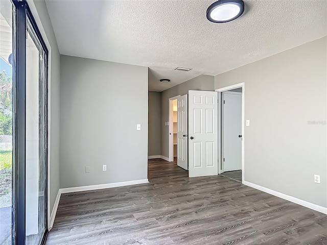 43 Lake Court Loop, Ocala, FL 34472 - unfurnished room featuring wood finished floors, baseboards, and a textured ceiling