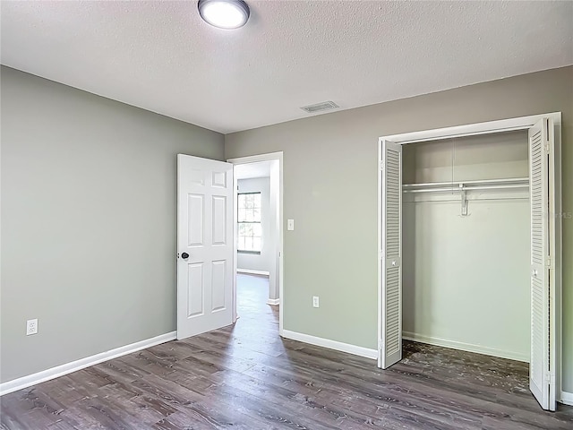 43 Lake Court Loop, Ocala, FL 34472 - unfurnished bedroom with dark wood-style flooring, baseboards, and a textured ceiling
