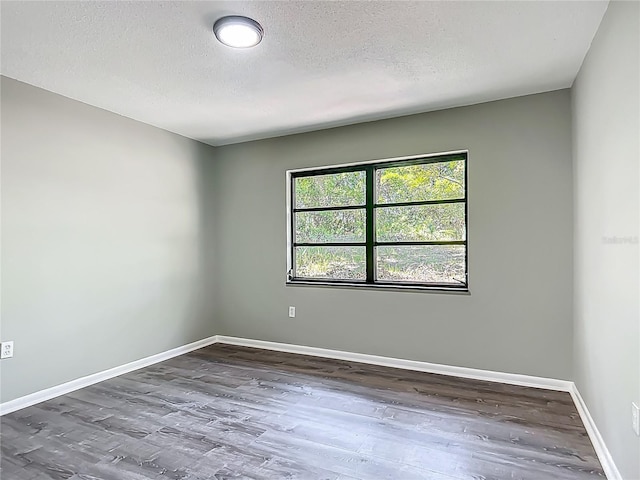 43 Lake Court Loop, Ocala, FL 34472 - empty room featuring a textured ceiling, wood finished floors, and baseboards