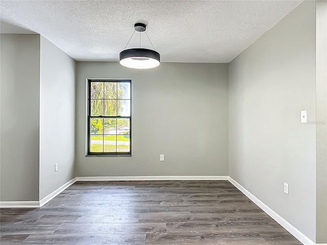 43 Lake Court Loop, Ocala, FL 34472 - empty room featuring a textured ceiling, dark wood-style floors, and baseboards