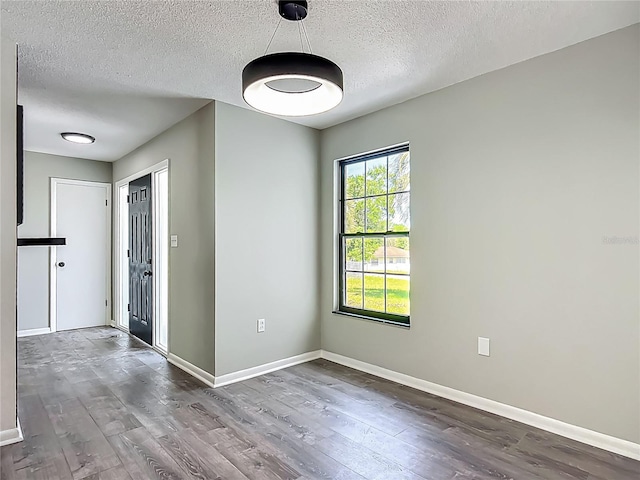 43 Lake Court Loop, Ocala, FL 34472 - spare room with wood finished floors, a textured ceiling, and baseboards