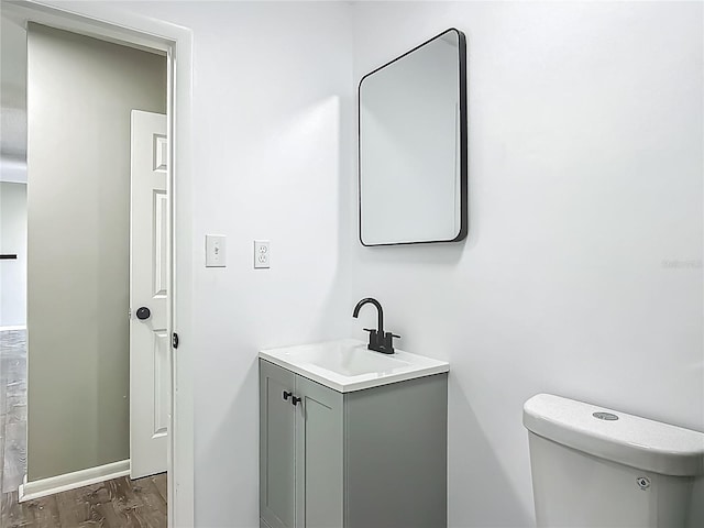 43 Lake Court Loop, Ocala, FL 34472 - bathroom with wood finished floors, vanity, toilet, and baseboards