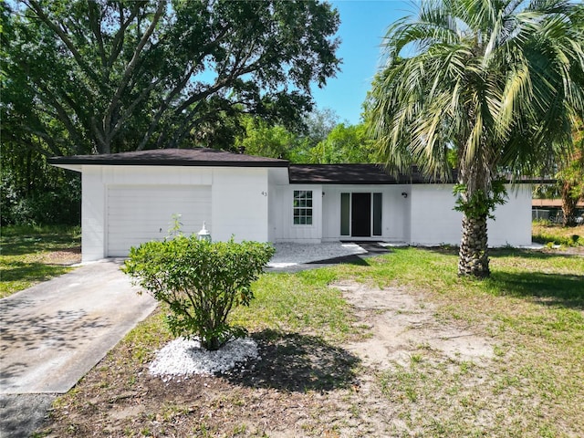 43 Lake Court Loop, Ocala, FL 34472 - back of property featuring an attached garage and driveway