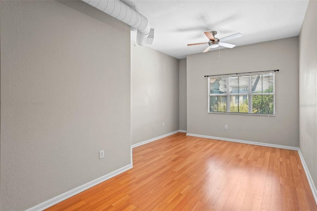 2411 W Horatio St Unit 537, Tampa, FL 33609 - empty room featuring a ceiling fan, light wood-type flooring, and baseboards
