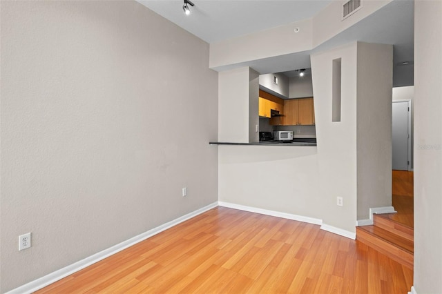 2411 W Horatio St Unit 537, Tampa, FL 33609 - spare room featuring light wood finished floors and baseboards