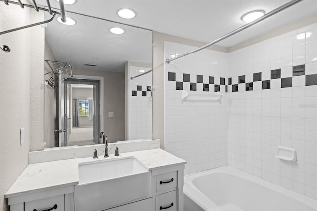 2411 W Horatio St Unit 537, Tampa, FL 33609 - full bath with bathing tub / shower combination, recessed lighting, vanity, and a textured wall