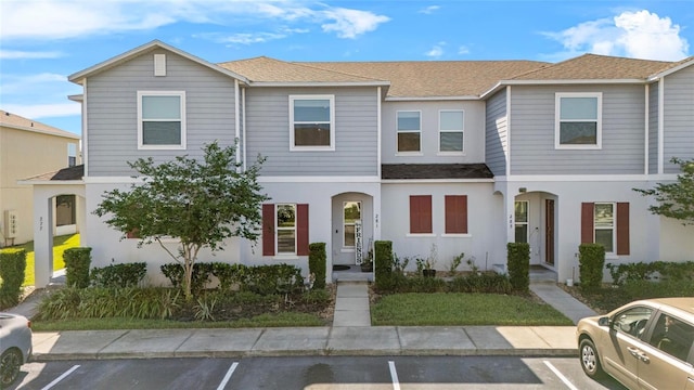 281 Primrose Dr, Davenport, FL 33837 - view of property with uncovered parking, a shingled roof, and stucco siding
