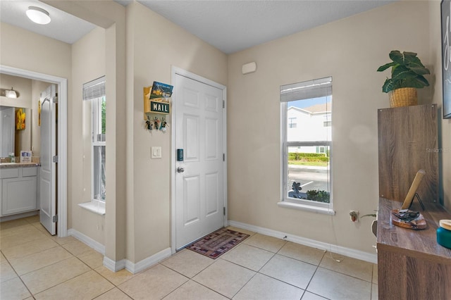 281 Primrose Dr, Davenport, FL 33837 - entryway featuring light tile patterned flooring and baseboards