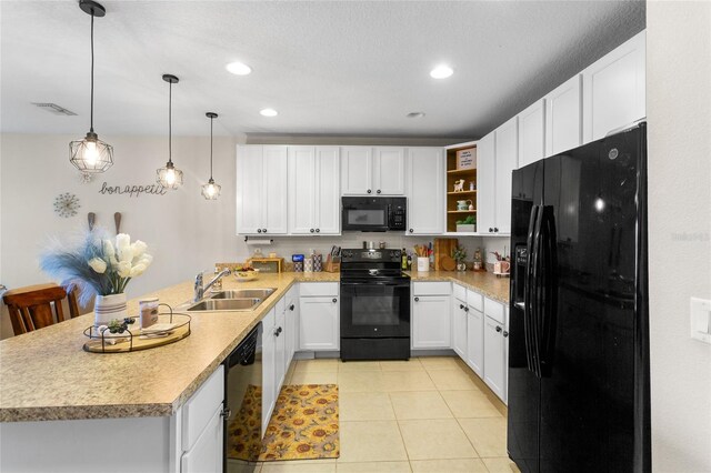 281 Primrose Dr, Davenport, FL 33837 - kitchen featuring black appliances, a sink, a peninsula, white cabinets, and light countertops