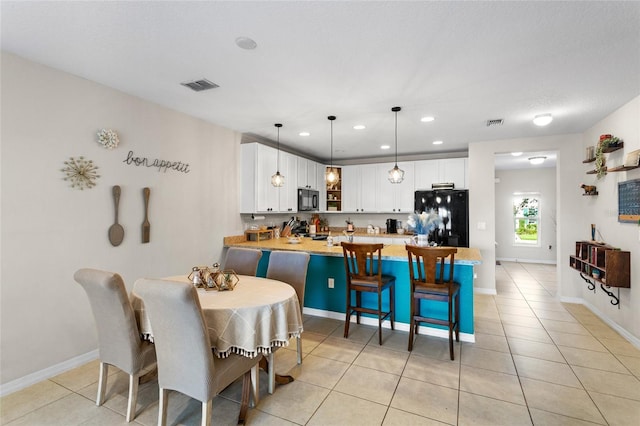 281 Primrose Dr, Davenport, FL 33837 - dining area with recessed lighting, light tile patterned floors, and baseboards